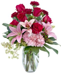 Rich red roses, blush pink Oriental lilies and hydrangea, deep burgundy carnations and sweet William are designed in this clear glass vase. Beautifully collared with rich green foliage.  Approximately 21"H X 15"W
