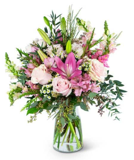 The Whispering Pink Meadow arrangement is soft and gentle enough to keep a secret or bold enough to declare your love and admiration. No matter your tone, this display of Roses, Asiatic Lilies, Alstroemeria, Snapdragons, Monte Cassino and premium greenery will get the message across